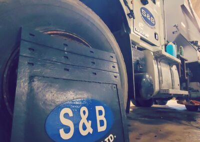 S & B Services Ltd truck mud flap sitting against tuck tire